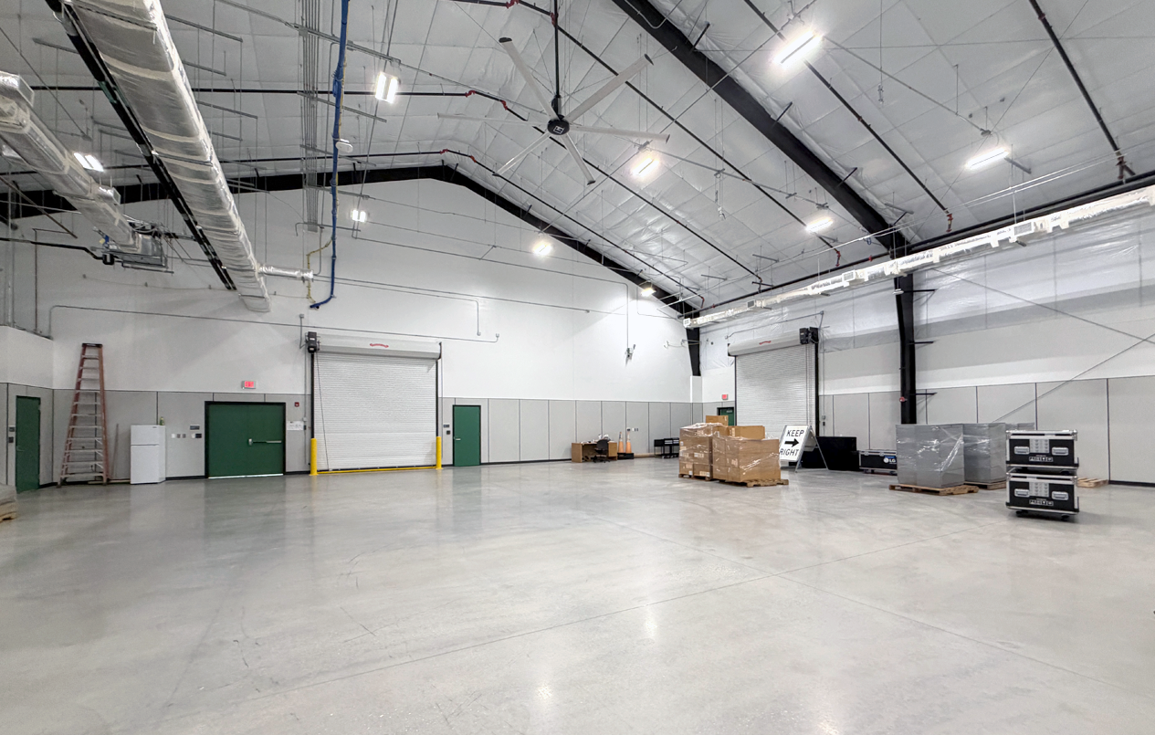 This is a picture of the Merch Yard with connecting roll-up doors in a Workshop Bay.
