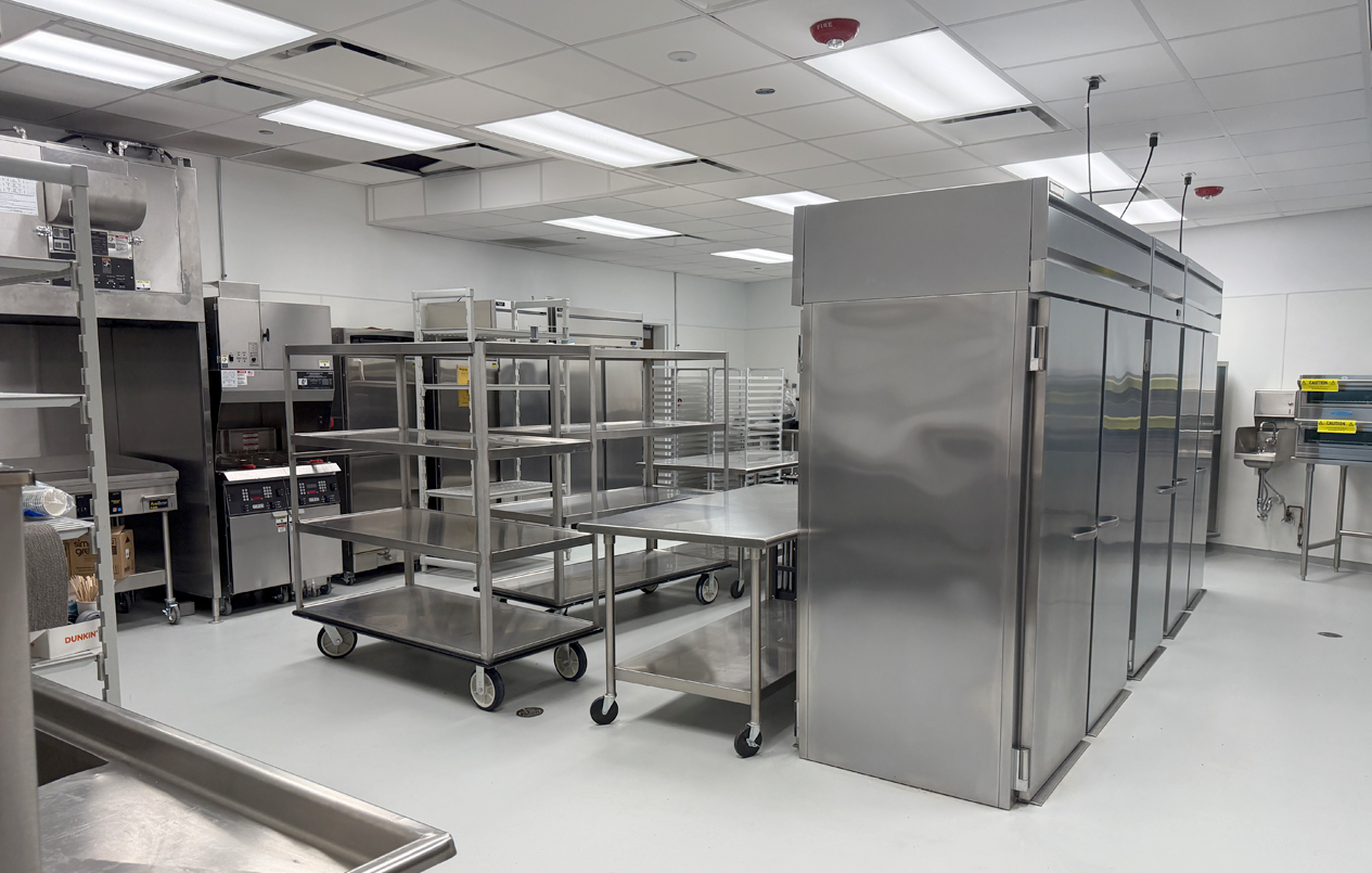 This is a picture of the Arrival and Conference building commercial grade kitchen with stainless steel appliances.